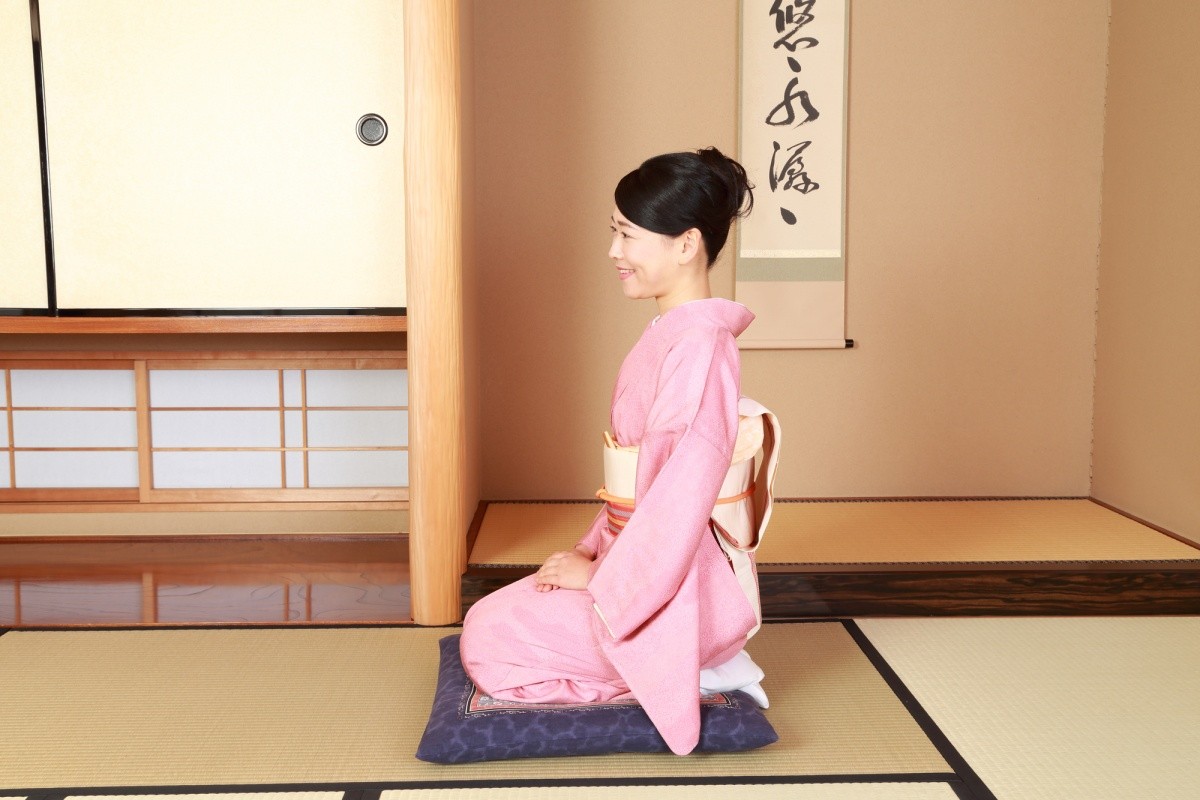 A woman sitting Japanese style on the floor